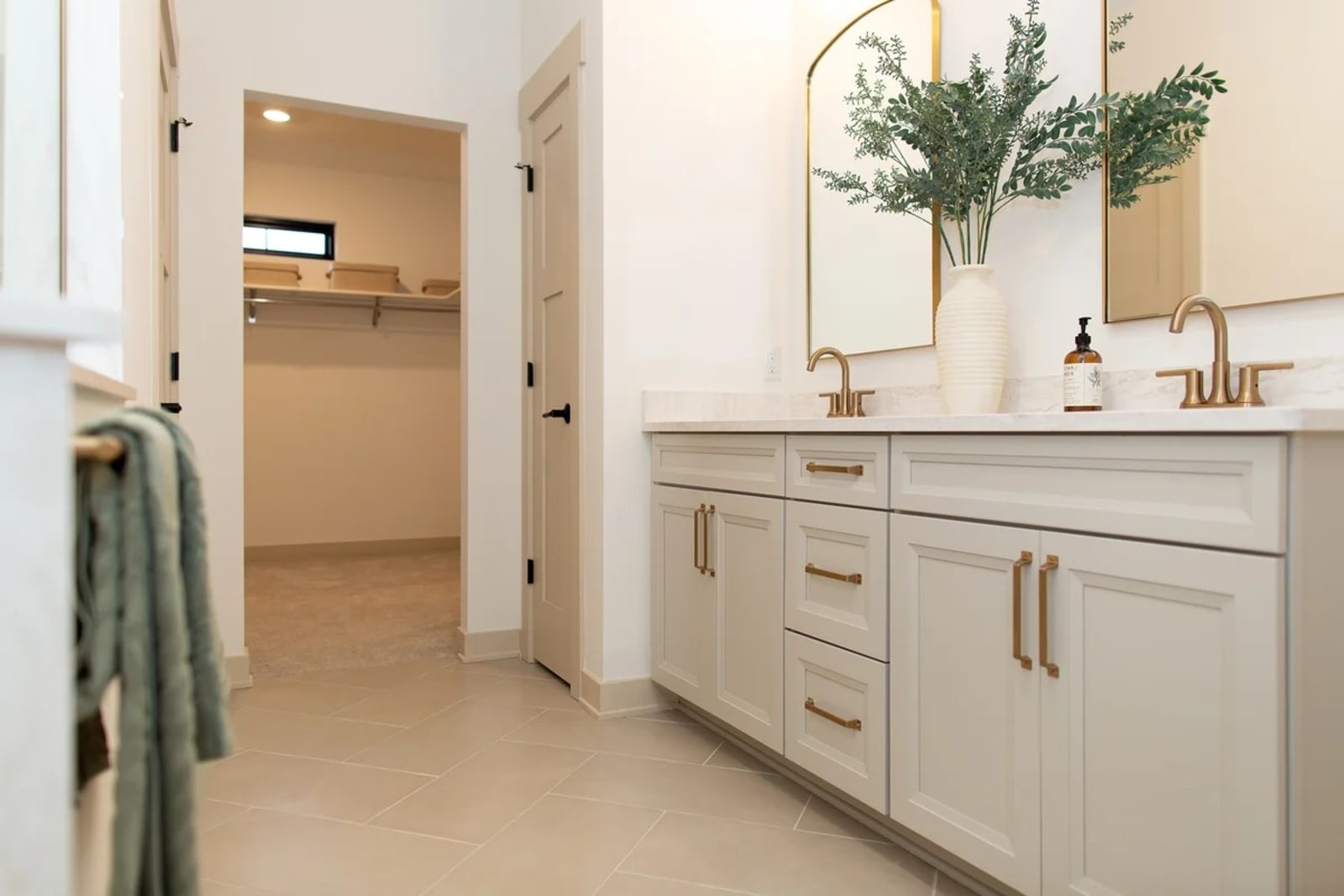 Bathroom with a fitted vanity, framed mirror and tiled surround